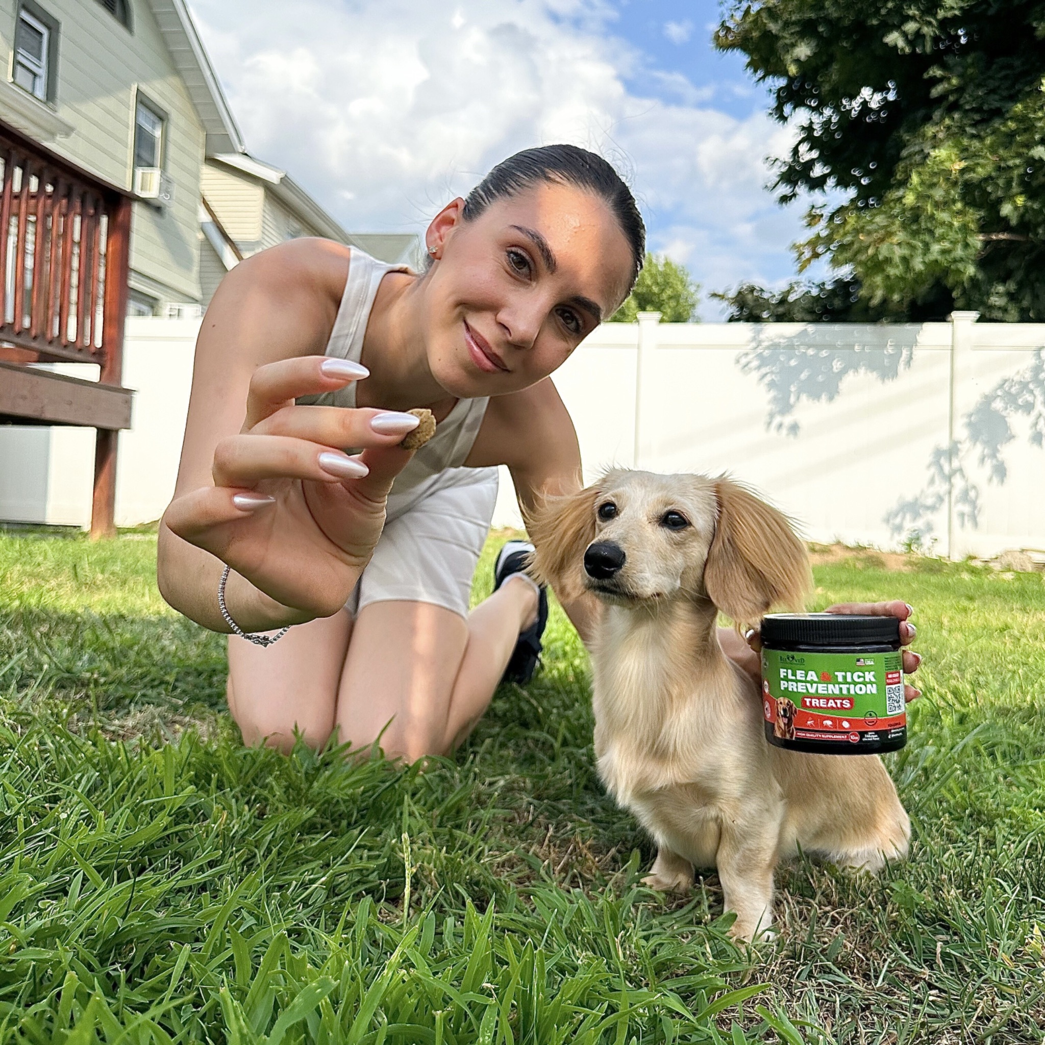 Girl with dachshund and Flea and Tick treats